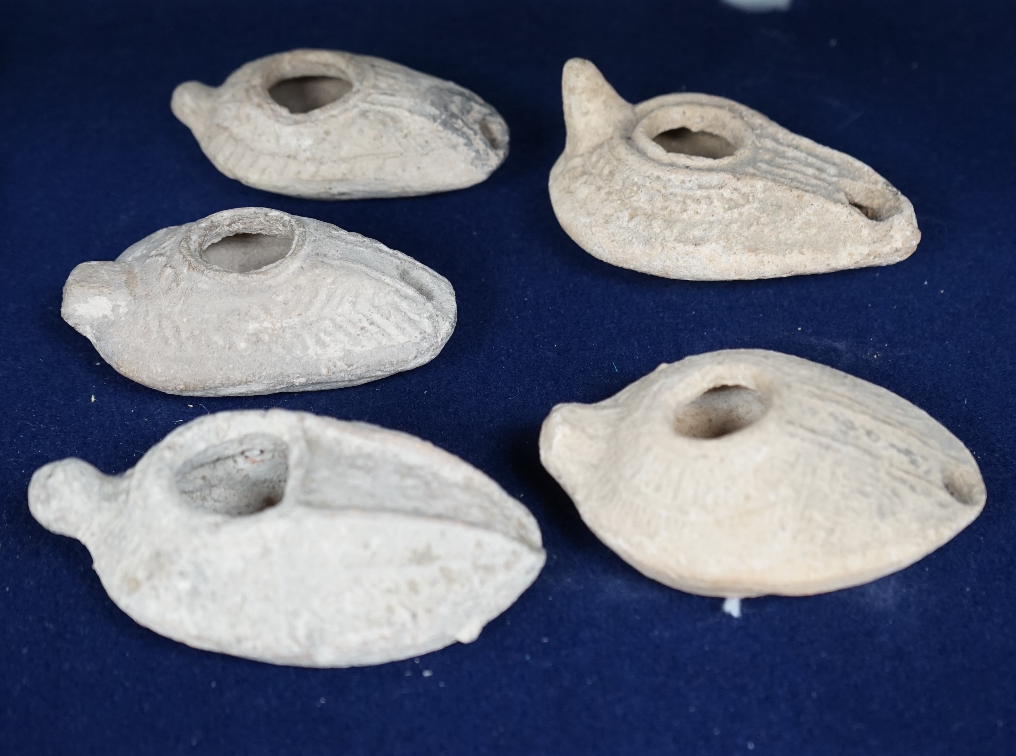 Five Roman terracotta oil lamps, 3rd century. Condition - poor to fair